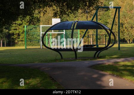 St Helens Church . Boultham Park Lincoln, Boultham Park, Lincoln, Lincolnshire, seating, shelter, area, park bench, picnic shelter, woodland, metal. Stock Photo