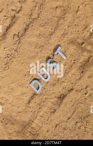 the word dust on dusty road surface in flat lay perspective Stock Photo