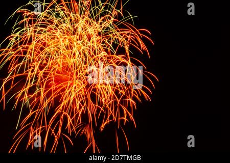 Night sky with fireworks display red green yellow upper left corner Stock Photo