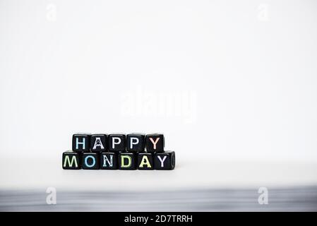 Happy Monday inscription of blocks on white page open notebook on desktop Stock Photo