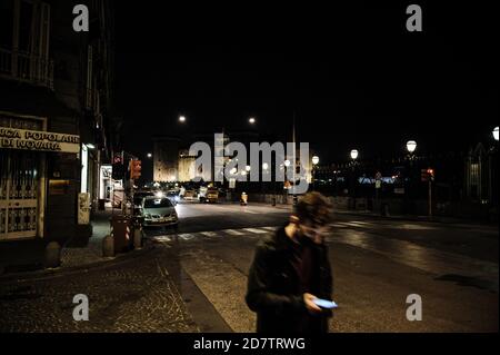 Naples, Italy. 23rd Oct, 2020. ITALY, NAPLES - OCTOBER 24, 2020 - A pedestrian walks wearing a protective mask in Via Vittorio Emanuele III in the Maschio Angioino presses in Naples, Italy on October 23, 2020. Today in Campania the ban on moving between the provinces of the region and the night curfew after 11pm imposed by the Royal Council of the President of the Campania Region Vincenzo De Luca as a form of containment of the Covid-19 virus comes into force, bringing a series of protests and disapproval from citizens and traders in the region due to the loss of job opportunities. On the sa Stock Photo