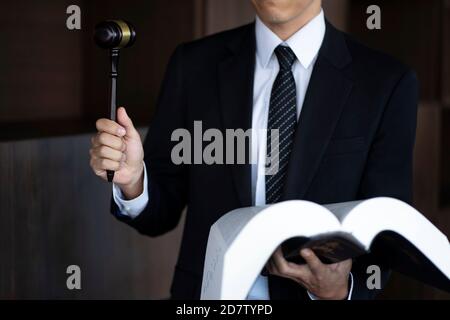 Lawyer holding gavel and law book Stock Photo