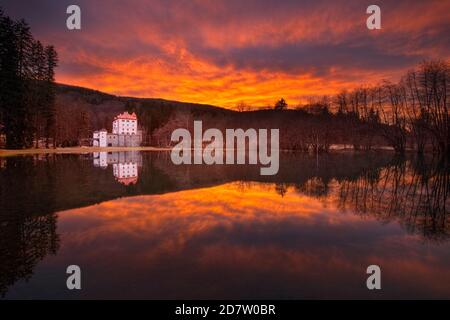 Sneznik Castle reflected in winter floodwater, near Kozarisce, Notranjska, Slovenia Stock Photo