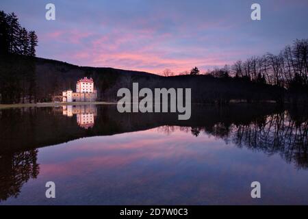 Sneznik Castle reflected in winter floodwater, near Kozarisce, Notranjska, Slovenia Stock Photo