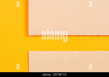 Brown blank cardboard with orange color paper background. Top view Stock Photo
