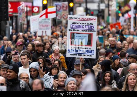 Placard held above marching crowd during an anti-lockdown rally in London, 24 October 2020 Stock Photo
