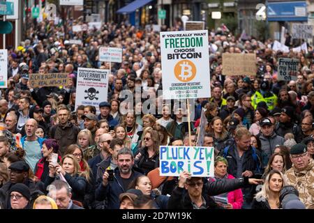 Placards held up above a marching crowd during an anti-lockdown rally in London, 24 October 2020 Stock Photo