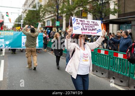 A marching protester holding up a placard during an anti-lockdown rally in London, 24 October 2020 Stock Photo