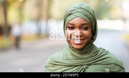 Black Muslim Woman With Braces Smiling To Camera Posing Outdoors Stock Photo