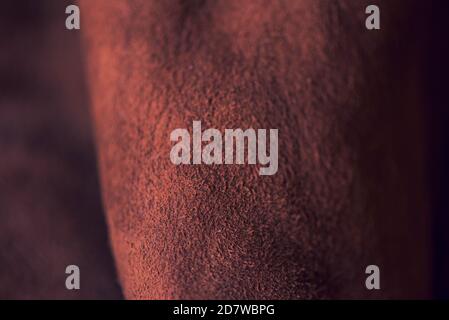 Brown matte background of suede fabric, closeup. Velvet texture of seamless leather. Felt material macro. Brown suede texture. Fabric, leather, materi Stock Photo