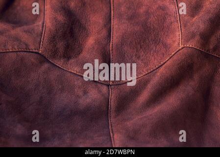 Brown matte background of suede fabric, closeup. Velvet texture of seamless leather. Felt material macro. Brown suede texture. Fabric, leather, materi Stock Photo