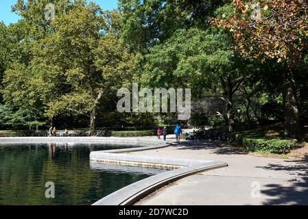 Conservatory Water is model boat pond in Central Park in Manhattan, New York City. Located in a natural hollow, the landscape slopes up on the sides. Stock Photo