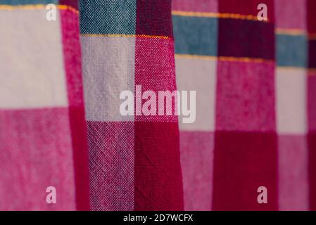 picnic cloth. The checkered tablecloth on a table. Texture of white fabric in a red cell. Background image. Blank checkered fabric texture Stock Photo