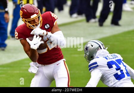 Landover, United States. 25th Oct, 2020. Washington Football Team tight end Logan Thomas (82) makes a catch over Dallas Cowboys safety Donovan Wilson (37) during the first half of an NFL football game at FedEx Field in Landover, Maryland, on Sunday, October 25, 2020. Photo by David Tulis/UPI Credit: UPI/Alamy Live News Stock Photo