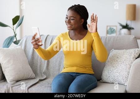 Cheerful Young Black Lady Having Video Call On Smartphone At Home Stock Photo