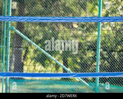 Volleyball net at the park with fallen leaf  in sunny autumn day Stock Photo