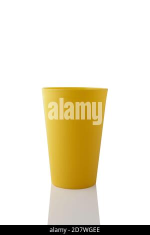 Plastic yellow cup isolated on white background. Stock Photo