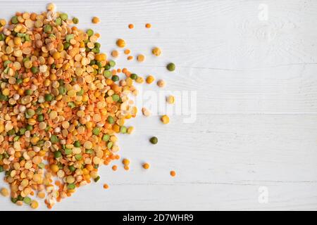 Dry peas of different colors close-up on a light background. Layout for grocery departments, poster, advertisement, article. Stock Photo