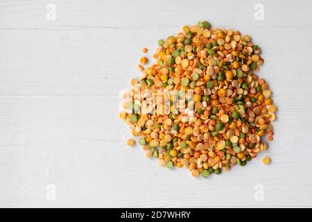 Dry peas of different colors close-up on a light background. Layout for grocery departments, poster, advertisement, article. Stock Photo