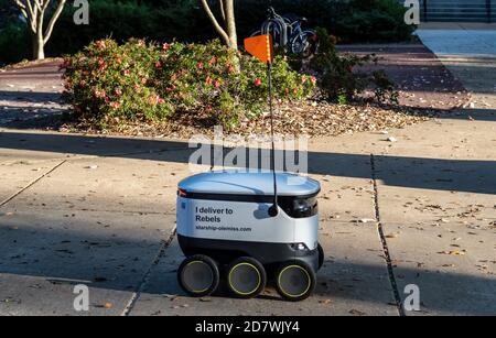 Starship Robot Delivery on  the campus of the University of Mississippi delivering food with Starship Technologies autonomous delivery service. Stock Photo