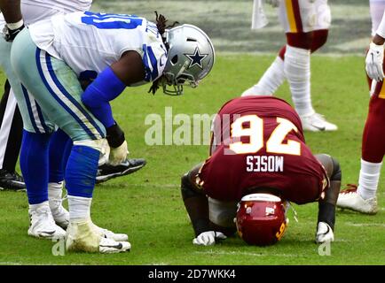 Landover, United States. 25th Oct, 2020. Dallas Cowboys defensive end DeMarcus Lawrence (90) checks on injured Washington Football Team offensive tackle Morgan Moses (76) during the second half of an NFL football game at FedEx Field in Landover, Maryland, on Sunday, October 25, 2020. Washington won 25-3. Photo by David Tulis/UPI Credit: UPI/Alamy Live News Stock Photo