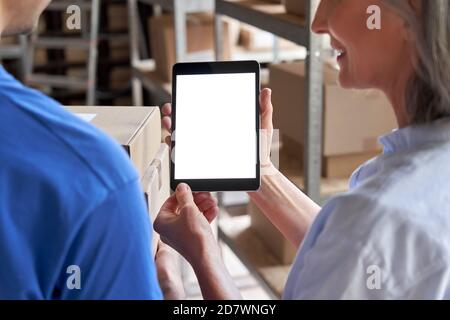 Inventory warehouse manager using digital tablet white screen talk to courier. Stock Photo
