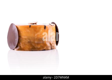 Sweet and tasty chocolate cake with almond and orange dressing on the white background. Stock Photo