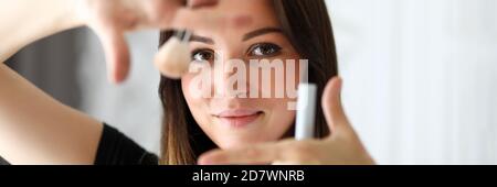 Woman make-up artist offers makeup for photo shoot Stock Photo
