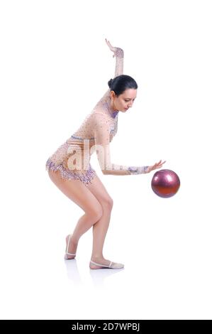 Beautiful artistic female gymnast working out, performing art gymnastics element Stock Photo