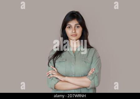 Confident serious indian business woman look at camera isolated on background. Stock Photo