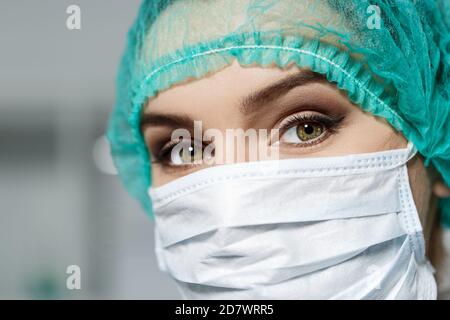 Female doctor's face wearing protective mask Stock Photo
