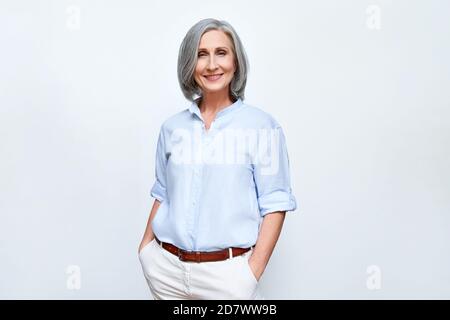 Smiling middle aged business woman standing isolated on white background. Stock Photo