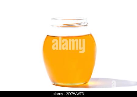 Glass jar with sweet honey isolated on white background Stock Photo