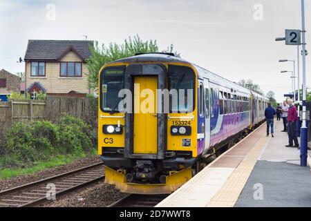 Class 153 single coach Sprinter railcar passenger train, coupled to a two-car class 150 Sprinter DUM, forming a three-car train, stopping at Langho. Stock Photo