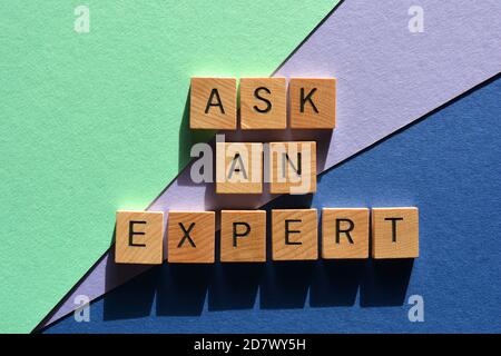 Ask An Expert, words in wood alphabet letters isolated on colorful background Stock Photo