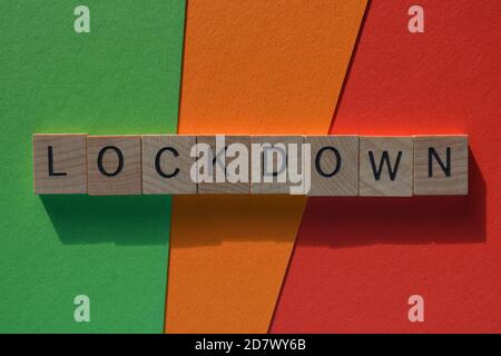 Lockdown, word in wooden alphabet letters in crossword form, isolated on colorful background Stock Photo