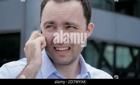 Handsome man talking by phone and walking over modern building b Stock Photo