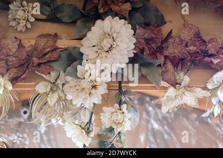 Christmas decorations - artificial flowers on blurred background. Selective focus. Stock Photo