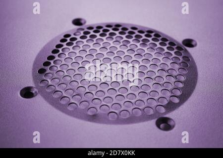 Close-up, shallow focus of a meshed style cooling panel used on a main frame computer. The circular holes aid active venting of hot air within the com Stock Photo