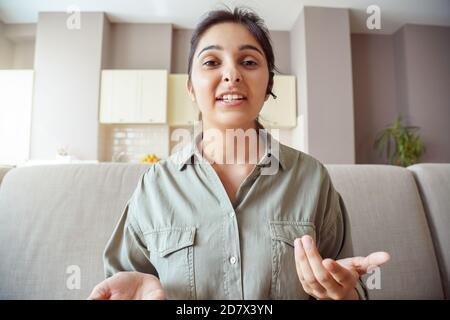 Indian woman online teacher wearing headset making conference video call. Stock Photo