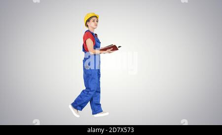 Female engineer in yellow safety helmet checking documentation w Stock Photo