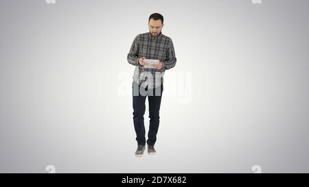 One guy holding and using one gradient tablet on gradient backgr Stock Photo