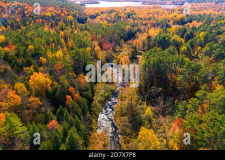 Aerial view of Winding River Through Autumn Trees with Fall Colors in Adirondacks, New York, New England Stock Photo
