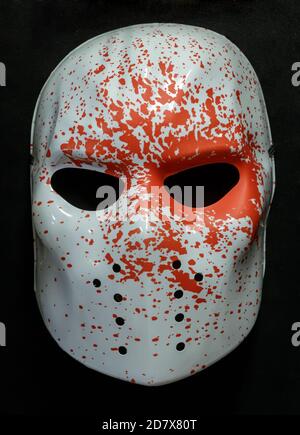 White Ice Rink Raider Mask With Blood Splatters on it Isolated Against Black Background Stock Photo
