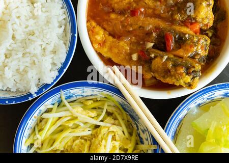 top view scrambled eggs with hotbed chives and deep fried fish and fuzzy melon with rice Stock Photo
