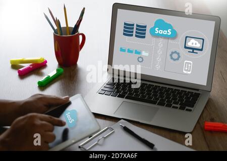 SAAS Thoughtful male person looking to the digital tablet screen saas Internet and technology Stock Photo