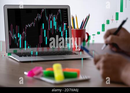 man Analyzing data graphs and reports investor with computer and tradeview graph Finance Stock Exchange finance traders Stock Photo