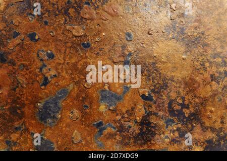 Shabby rusty background. Damaged orange painted cement wall. Rust stains. Stock Photo