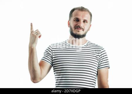 Young handsome bearded man wearing striped t-shirt showing and pointing up with finger number one Stock Photo