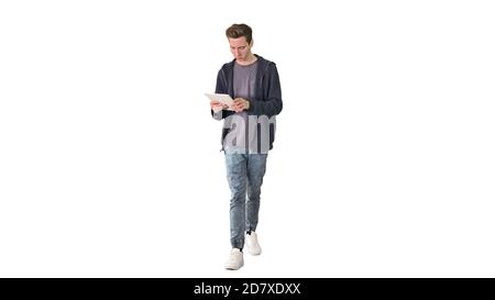 Casual man using tablet while walking on white background. Stock Photo